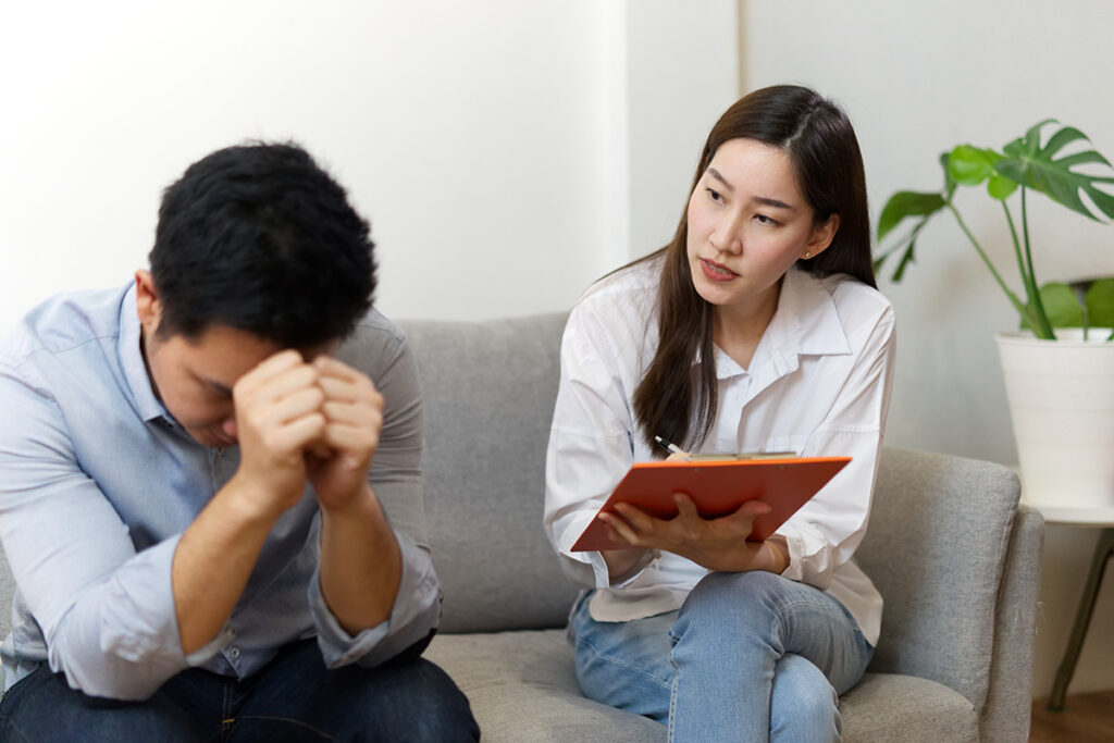 a therapist sits on a couch with her patient who is struggling with long term effects of heroin