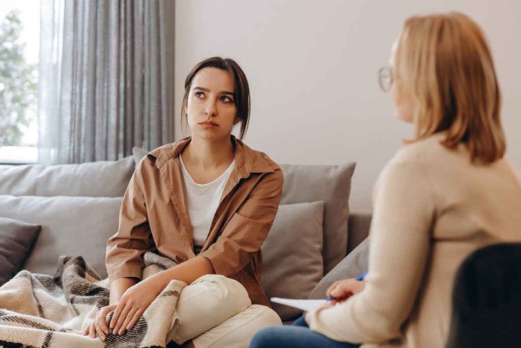 female therapist counsels young woman in an office setting by offering 3 tips for avoiding relapse
