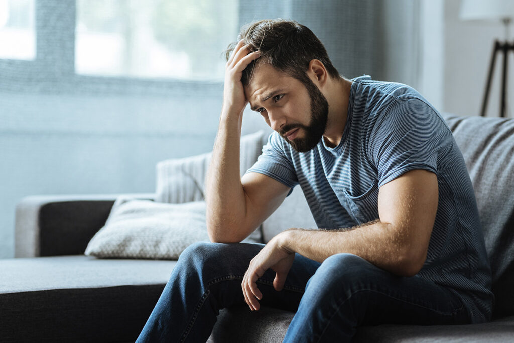 Person thinking about the signs of bipolar disorder in men
