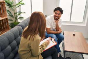 a man sitting on a couch and smiling